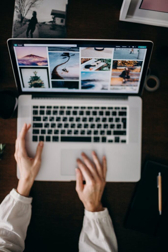 pexels-photo-3584993 Hands using a laptop to browse photo galleries, illustrating digital creativity and remote work.